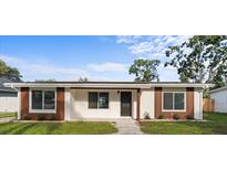 Charming single-story home featuring a well-maintained lawn, neutral colors, and updated windows at 1740 Lucas Dr, Clearwater, FL 33759
