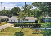 Charming single-story home with a well-maintained lawn and mature landscaping, complemented by a paved driveway at 1937 N Highland Ave, Clearwater, FL 33755