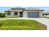A charming single-story home boasts a gray roof, manicured lawn, and a paved driveway leading to an attached garage at 27 Bunker Ct, Rotonda West, FL 33947
