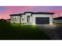 Beautiful single-Gathering home with manicured lawn and modern design elements in a serene setting at 3323 Elkcam Blvd, Port Charlotte, FL 33952