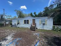 Cozy single-story home with white siding and a small front porch, surrounded by a partially landscaped yard at 12141 Terra Ceia Ave, New Port Richey, FL 34654