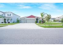 Charming single-story home featuring a well-maintained lawn and a three-car garage at 11818 Tetrafin Dr, Riverview, FL 33579