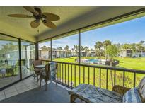 Screened patio overlooking green space and community pool at 3805 E Bay Dr # 204, Holmes Beach, FL 34217