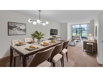 An elegant dining area flows into the living room with views of the golf course at 1967 Cormorant Ct # 516, Clearwater, FL 33762