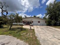 Charming single-story home featuring a two-car garage and a brick facade at 5627 Oakland Dr, Tampa, FL 33617