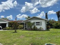 Charming single-story home with a well-maintained lawn and vibrant landscaping at 4650 Orlando Cir, Bradenton, FL 34207