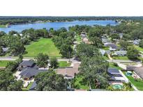 Expansive aerial view of a neighborhood with lush greenery and a large lake in the background at 2531 Lake Ellen Dr, Tampa, FL 33618