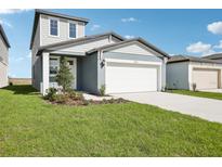 Charming two-story home with a well-maintained lawn, two car garage and meticulous landscaping at 3544 Moscato Dr, Brooksville, FL 34602