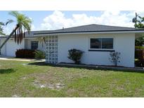Charming single-story home with a well-maintained lawn and tropical landscaping at 9093 108Th St, Seminole, FL 33772