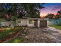 Charming home featuring a well-manicured lawn, quaint walkway, and attached one car garage at 6208 S Harold Ave, Tampa, FL 33616