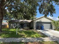 Charming single-story home featuring a well-maintained front yard and attached two-car garage at 837 Greenbelt Cir, Brandon, FL 33510
