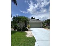 Charming single-story home with well-manicured landscaping, palm trees, and a paved driveway at 4924 Creekside Trl, Sarasota, FL 34243