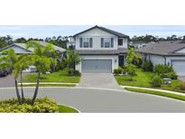 Charming two-story home with a well-maintained lawn and inviting curb appeal at 6256 Baywood Ct, Bradenton, FL 34211