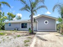 Charming single-story home featuring a well-maintained yard and modern architectural details at 7341 Hart St, Englewood, FL 34224