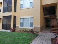 Inviting exterior view with landscaped front and staircase access in a well-maintained building at 4307 Bayside Village Dr # 103, Tampa, FL 33615