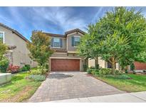 Charming two-story home featuring a brick driveway and a well-manicured front yard with mature trees at 12990 Burns Dr, Odessa, FL 33556