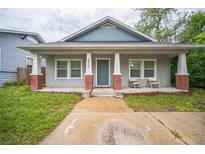 Charming bungalow with a cozy front porch and tidy landscaping; ideal for relaxing outdoors at 3610 N Tampa St, Tampa, FL 33603