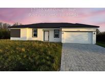 New construction home with a two-car garage and paved driveway at 12168 Van Gough Ave, Port Charlotte, FL 33981