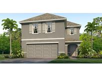 Two-story house with gray siding, double garage, and landscaping at 30979 Wild Juniper Ct, Brooksville, FL 34602