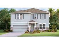 Two-story house with gray siding, stone accents, and a two-car garage at 7479 Rome Ln, Brooksville, FL 34613
