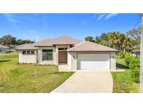 Single-story home with attached garage and landscaped lawn at 49 Marajo St, Punta Gorda, FL 33983