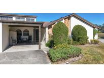 Inviting exterior featuring a covered patio and well-manicured landscaping at 9147 Lingrove Rd, Weeki Wachee, FL 34613