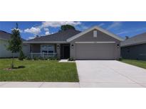 Charming single-story home with a well-maintained lawn and a two-car garage at 13221 Gulf Bay Ln, Spring Hill, FL 34609