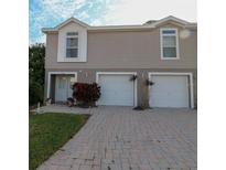 Charming two-story townhouse with attached garages and a brick driveway at 4939 Marina Palms Dr, Port Richey, FL 34668