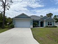 Charming single-story home with a well-manicured lawn and a two car garage at 1220 Gantry Rd, North Port, FL 34288