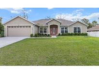 Charming single Gathering home featuring a spacious lawn, attached two car garage and meticulous landscaping at 4196 Hoffman Ave, Spring Hill, FL 34606