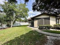 Cozy home featuring a well-maintained lawn and a charming walkway leading to the front door, surrounded by lush greenery at 4622 Blossom Blvd # D, Zephyrhills, FL 33542