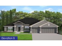 Charming one-story home featuring gray stucco, a three-car garage, and a manicured lawn surrounded by lush, mature trees at 10416 Calico Warbler Ave, Weeki Wachee, FL 34613