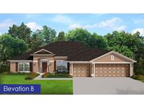 Charming single-story home with a three-car garage, manicured lawn, and beautiful landscaping at 13144 Convent Garden Rd, Brooksville, FL 34613