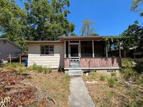 Charming single-story home with a cozy front porch and mature trees at 655 36Th S Ave, St Petersburg, FL 33705