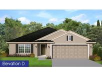 Charming single-story home featuring a two-car garage, neutral siding, dark roof, and manicured front lawn at 4889 Sutherland St # Lot 53, Spring Hill, FL 34609