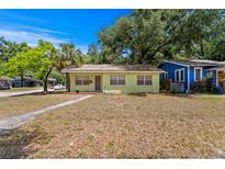 Charming single-story home with a well-maintained lawn and mature trees in a peaceful neighborhood at 107 W Woodlawn Ave, Tampa, FL 33603