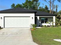 Beautiful single-story home featuring a well-manicured lawn, two-car garage, and a modern design at 2370 Allsup Ter, North Port, FL 34286