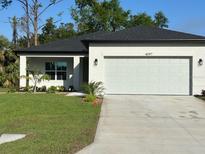 Charming single-story home with a well-manicured lawn and a spacious two-car garage at 4097 Feather Ter, North Port, FL 34286