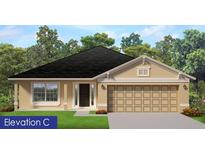 Charming single-story home featuring a two-car garage, well-manicured lawn, and stylish architectural details at 4858 Sutherland St # Lot 61, Spring Hill, FL 34609