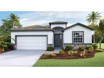 Inviting single-story home with a stone-accented facade, two-car garage, and beautifully landscaped front yard at 11332 Curio Dr, Brooksville, FL 34613