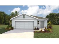 Charming single-story home featuring a two-car garage, manicured lawn, and complementary landscaping at 11771 Memorial Dr, Brooksville, FL 34613