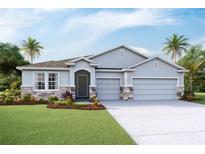 Charming single-Gathering home with a three-car garage, stone accents, and a well-manicured lawn at 11296 Curio Dr, Brooksville, FL 34613