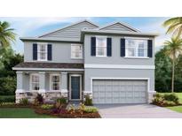 Two-story home featuring stone accents, gray siding, dark shutters, and a two-car garage at 11352 Curio Dr, Brooksville, FL 34613