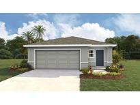 Charming single-story home with a gray exterior, attached two-car garage and a well-manicured lawn at 11745 Memorial Dr, Brooksville, FL 34613