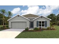 Charming one-story home with a two-car garage, gray exterior, and well-manicured lawn and mature landscaping at 11766 Memorial Dr, Brooksville, FL 34613