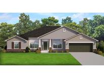 Inviting single-story home featuring manicured lawn, gray siding, dark roof, and an attached two-car garage at 14351 Carolina Chickadee Rd, Weeki Wachee, FL 34614