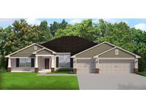 Charming single-story home with neutral siding, two-car garage, well-maintained lawn, and inviting front entrance at 12142 Pine Warbler Ave, Brooksville, FL 34614