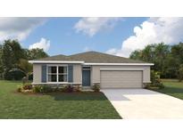 Charming single-story home featuring stone accents, a two-car garage, and a well-manicured lawn at 10414 Tucker Rd, Weeki Wachee, FL 34613