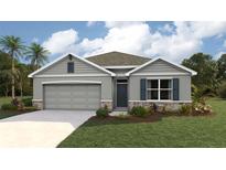 Charming single-Gathering home featuring a two-car garage, manicured lawn, and stone accents at 10434 Tucker Rd, Weeki Wachee, FL 34613