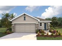 Charming single-story home featuring a neutral color palette, stone accents, and a two-car garage, set in a landscaped yard at 10452 Tucker Rd, Weeki Wachee, FL 34613
